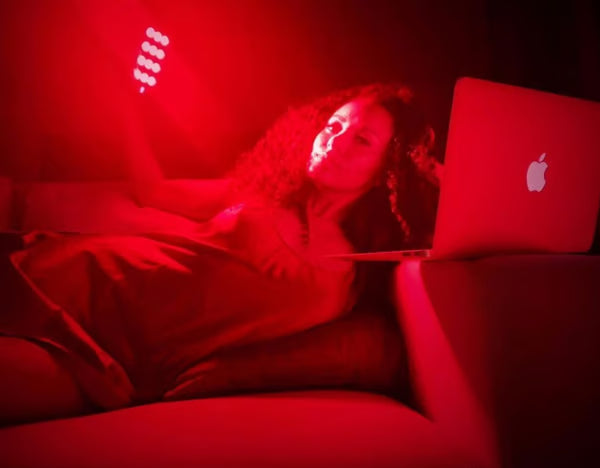 A woman using the Vital Charge red light therapy device for hormonal regulation|Hormonal Balance|natural hormone balance