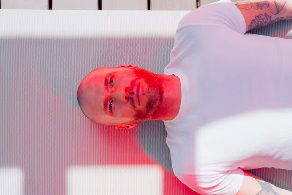 Man sleeping in front of red light therapy - Vital Red Light|Man sleeping with red light therapy|Man sleeping in front of red light therapy - Vital Red Light